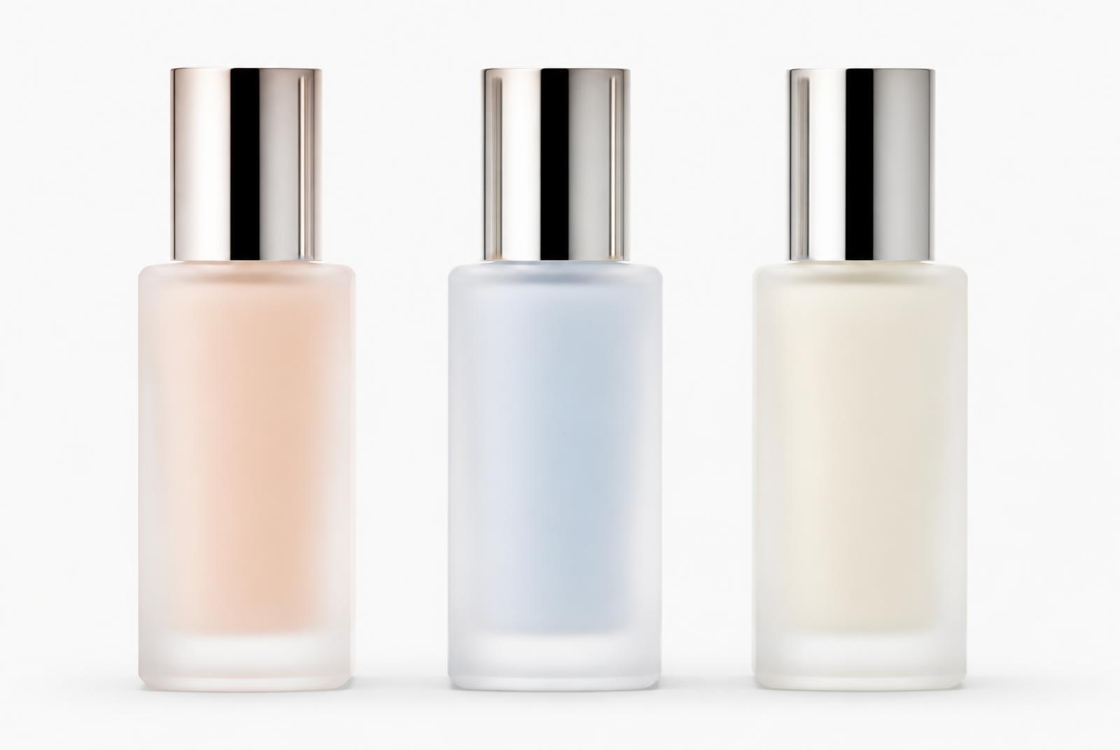 Three frosted glass bottles in nude, ice blue and ivory